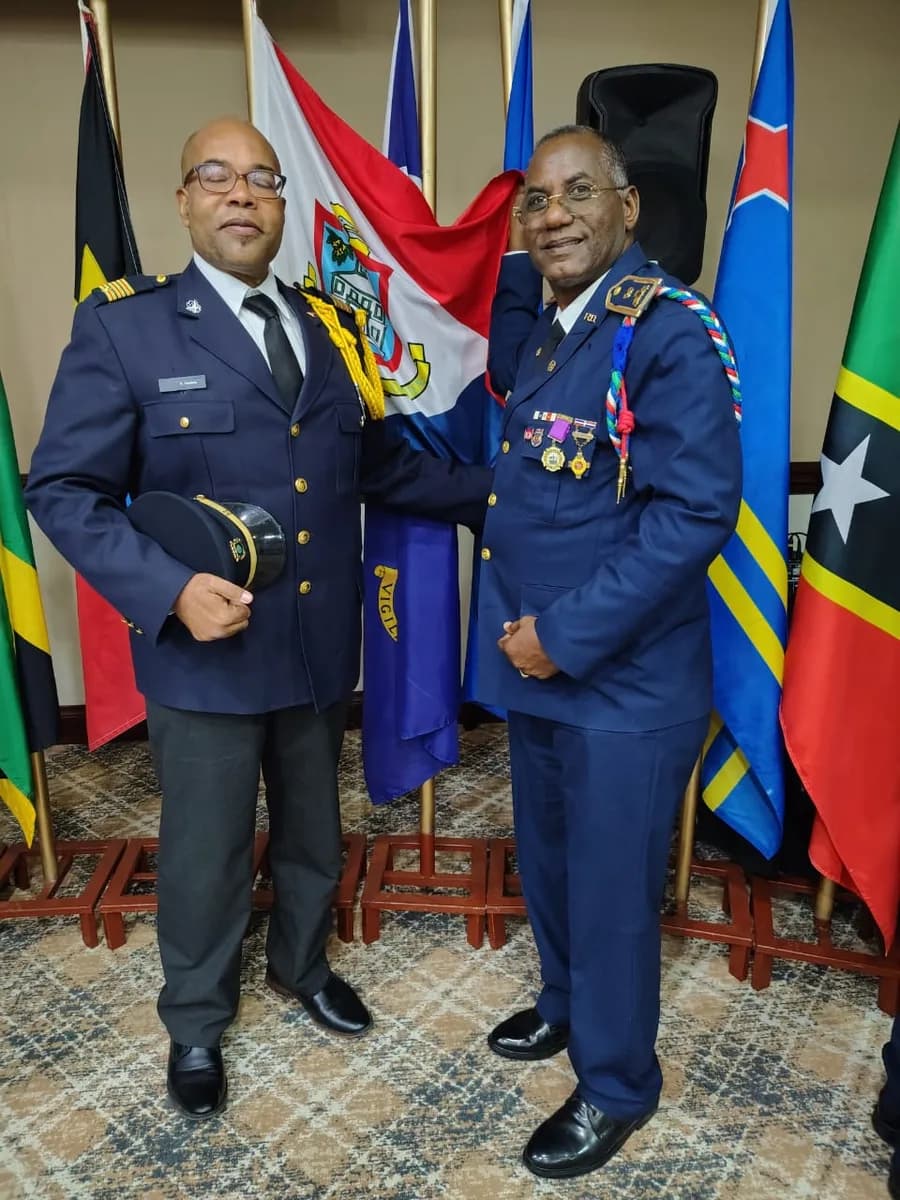 Senior fire officers in dress uniform with Caribbean flags